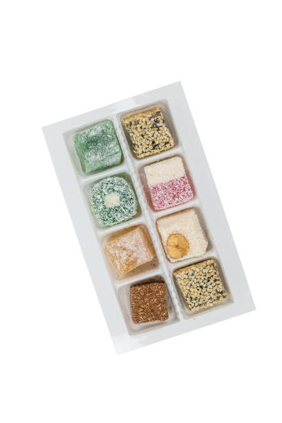 istock Assorted Turkish delight in a plastic box isolated on a white background. 1327277827