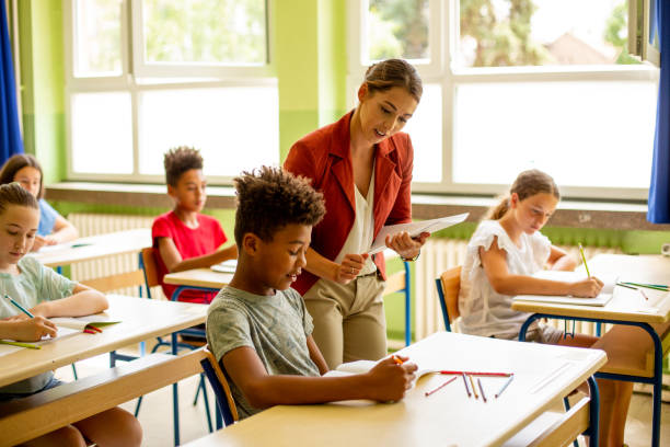 istock Young African American boy asking teacher for little help. 1327279734