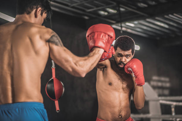 istock Two kickboxers working on kicks in a gym 1327280760