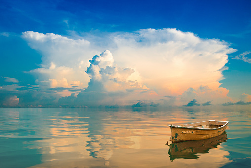 Dream world - small island in ocean - boat in sunrise