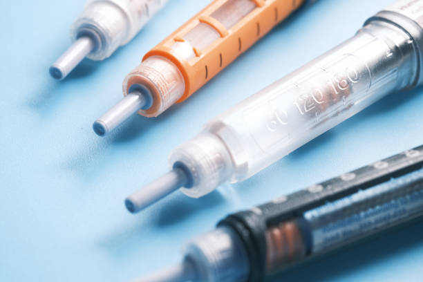istock Insulin pens on pink background, close up 1327281341