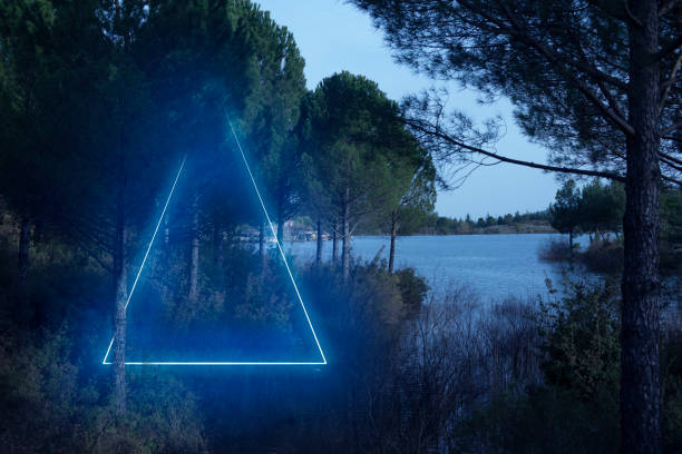 istock Blue neon triangle light lake view and behind the trees ,futuristic visual effect 1327289548