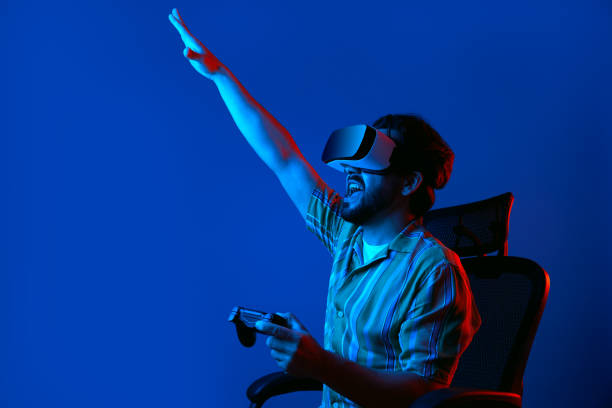 istock Young man in VR glasses screams and celebrates winning in virtual game 1327289701