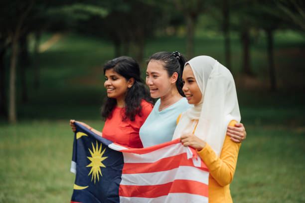 istock Malaysian multi-ethnic group people with Malaysian flag at public park 1327291355