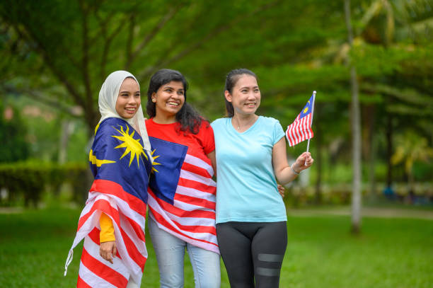 istock Malaysian multi-ethnic group people with Malaysian flag at public park 1327291368
