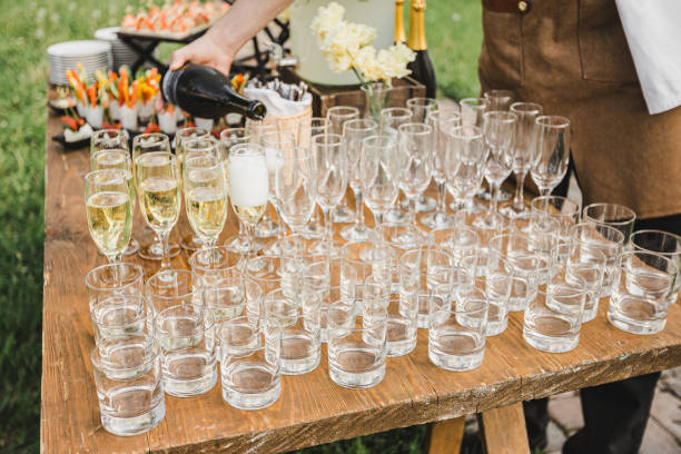 istock The bartender pours champagne into glasses. 1327291554