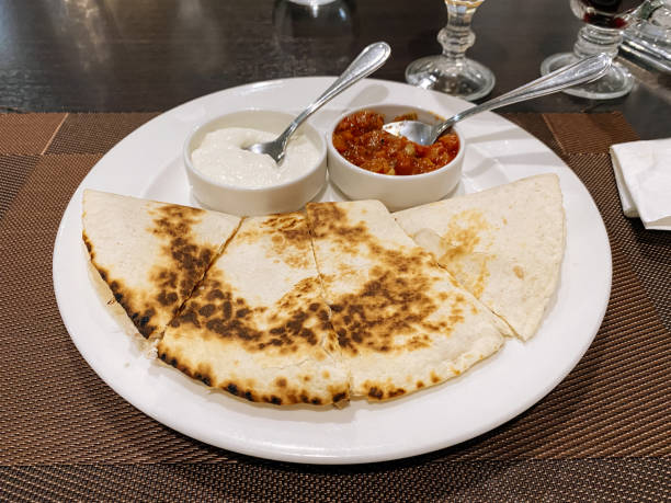 istock Quesadilla with sauce in plate on wooden plank 1327295553