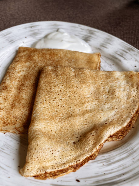 istock plate of russian pancake with sour cream 1327295665