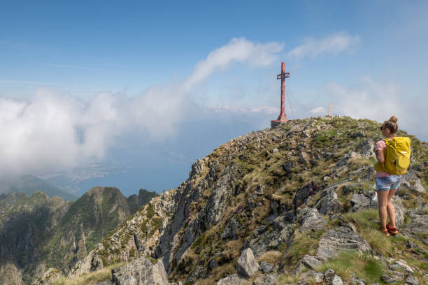 Hiker female walks on top of mountain. Ticino canton, Switzerland