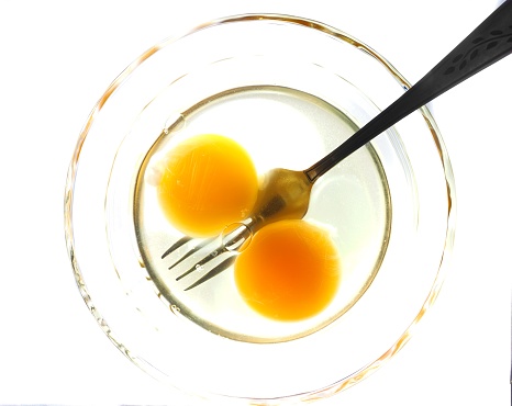 Eggs illuminated with strong backlight. Strong backlighting shows the texture color and detail of eggs in a clear glass bowl.