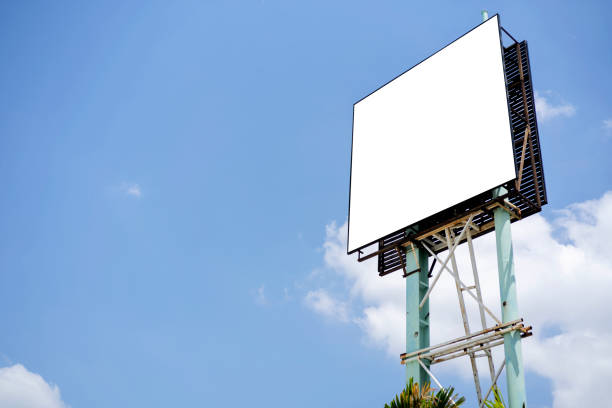 istock Blank billboard mockup with white screen against clouds and blue sky background. 1327299056