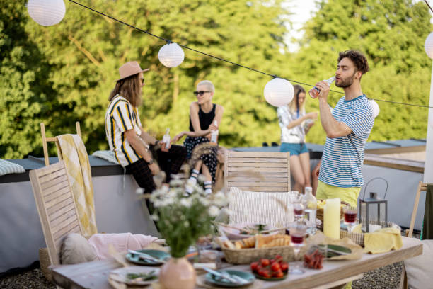 istock Young stylish friends having a festive dinner on the roof terrace 1327299577