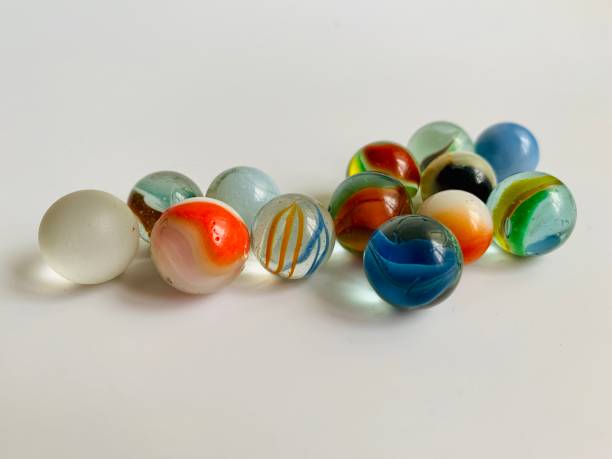 istock Glass marbles in white background 1327300628
