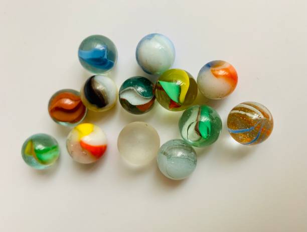 istock Glass marbles in white background 1327300638