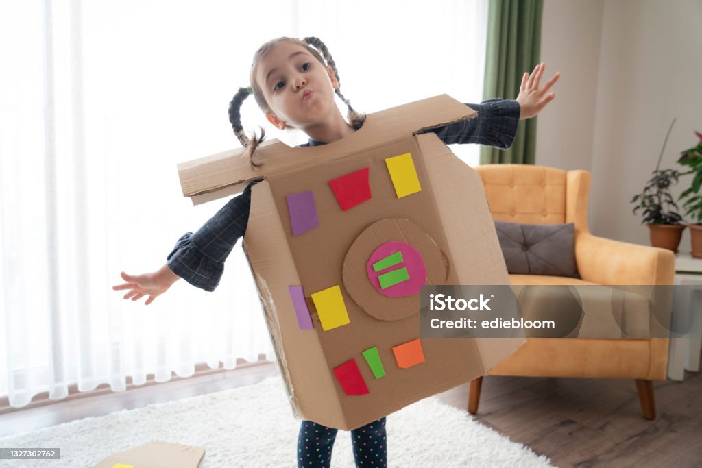 Robot Girl cute child is wearing cardboard robot costume at home Child Stock Photo