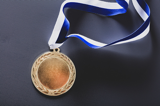 Gold medal on velvet cushion. Olympic games award