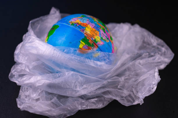 istock Mock Planet Plastic Bag Black Background Concept Saving Our Planet Earth 1327303210