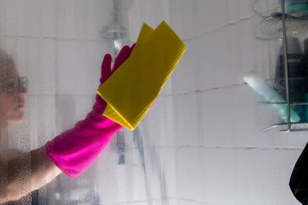 istock woman cleaning shower 1327304127