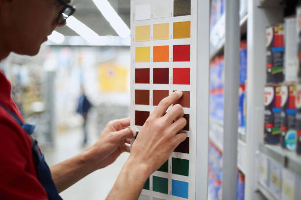 man choosing a suitable sample of the desired paint stock photo