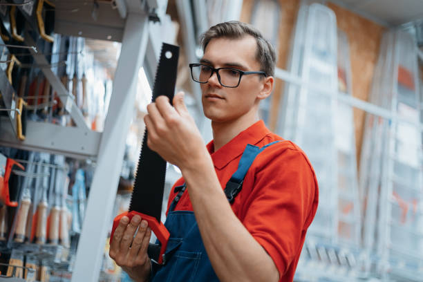 istock hardware store clerk checking the markings on a hand hacksaw 1327304703
