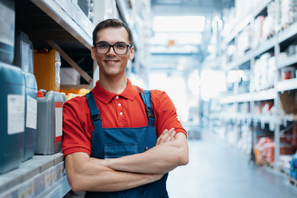 smiling supervisor standing in the sales area of a hardware store stock photo