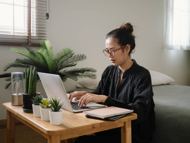 donna che impara online con il laptop. - colleague looking at camera indoors lifestyles foto e immagini stock