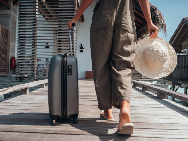 istock Woman pulls trolley on wooden pier in tropical destination 1327308310
