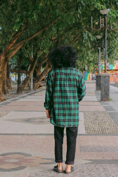 istock Southeast Asian man walking in a park 1327308804