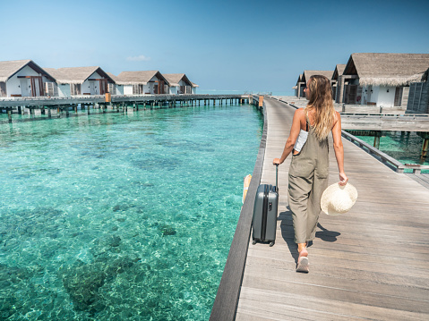 Low angle view of woman arriving in hotel, Maldives