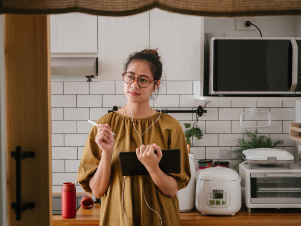 istock Asian woman working from home. 1327310424