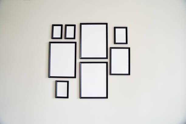 istock Different size framed photos hanging on the gray wall. Mockup 1327312124