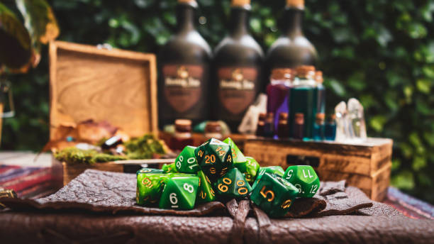 a pile of green RPG gaming dice Image of a pile of green RPG gaming dice on top of a leather-bound book. Within the background wooden boxes with bottles containing a various colored liquid polyhedron stock pictures, royalty-free photos & images