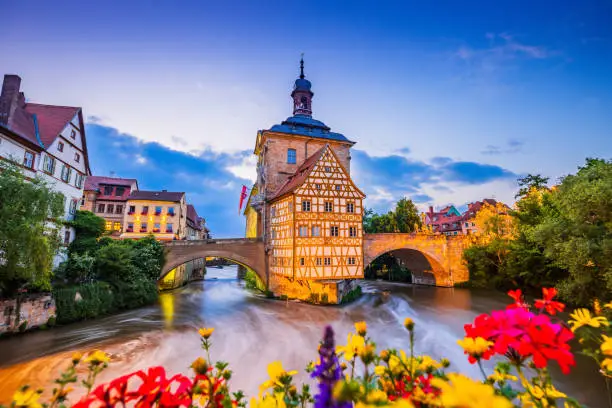 Bamberg, Germany. Town Hall of Bamberg (Altes Rathaus) with two bridges over the Regnitz river. Upper Franconia, Bavaria.