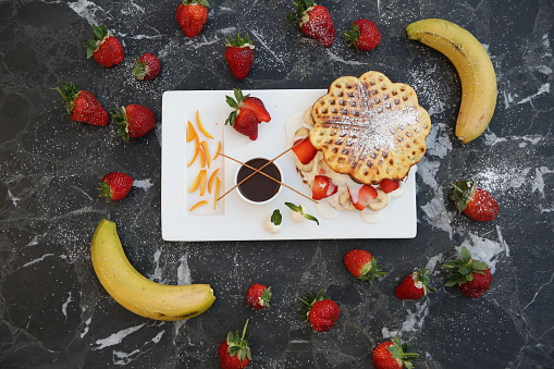 Waffles with strawberries, bananas and honey