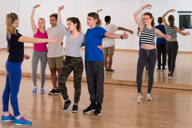 Photo of happy teens studying folk style dance