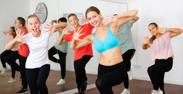 istock Teenagers exercising with coach in choreography class 1327320847