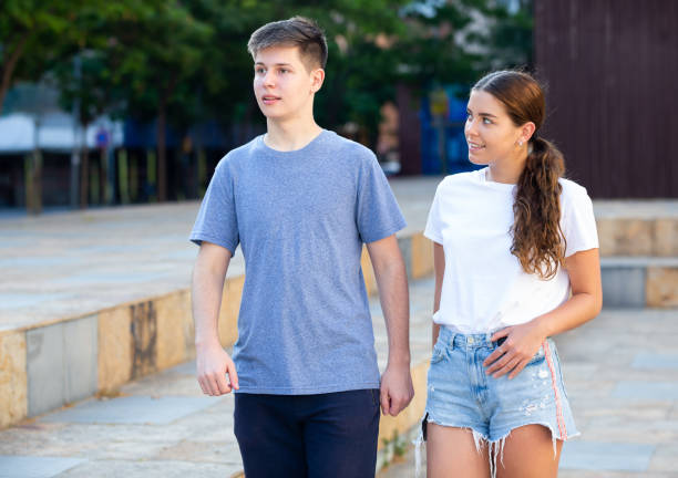 istock Two teenagers are sitting on parapet and talking 1327320948