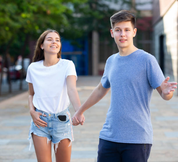 istock Two youngsters are walking hand in hand 1327320970