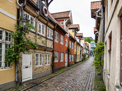 Colorful half timbered living houses in a row along the Oluf Samson street in old town of Flensburg, Germany