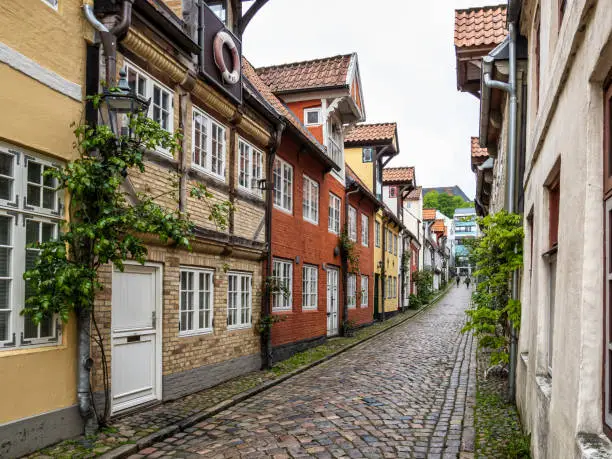 Photo of Colorful half timbered living houses in a row along the Oluf Samson street in old town of Flensburg, Germany