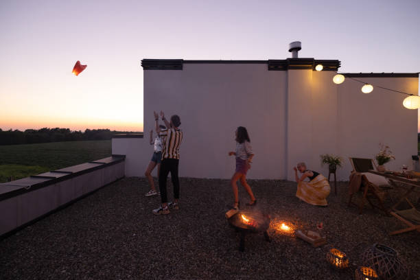 istock Friends have a roooftop party at night 1327329884