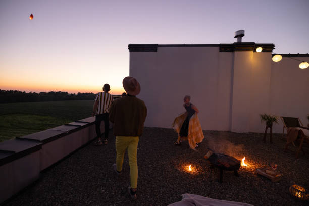 istock Friends have a roooftop party at night 1327329891