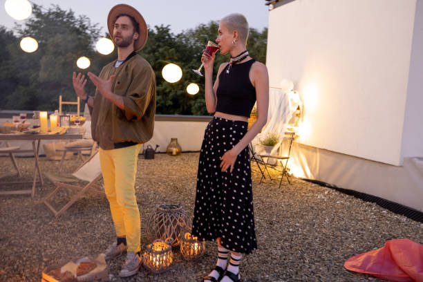 istock Friends by a fireplace on the rooftop at sunset 1327329935