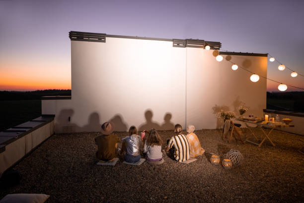 istock People watching movie on the rooftop terrace at sunset 1327330193