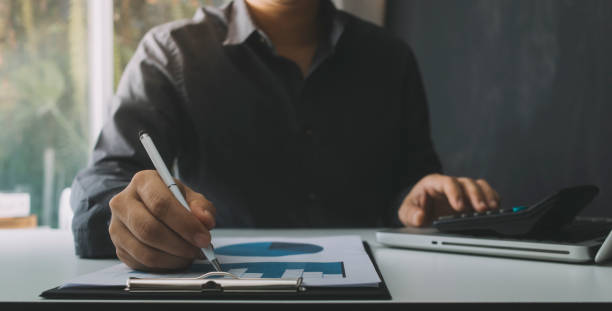 istock Business women reading document on office with tablet and graph financial diagram.Teamwork workplace strategy Concept. 1327331435