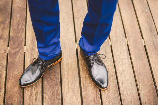 istock Groom in blue trousers and black shoes 1327331632
