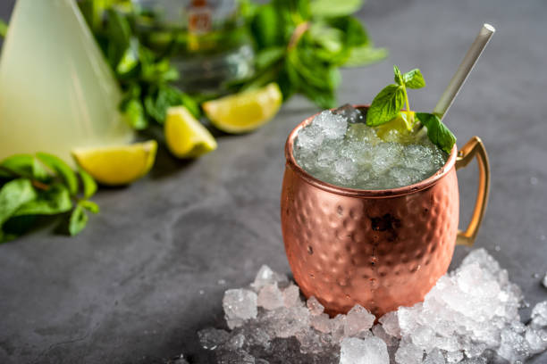 istock Moscow mule cocktail in copper cup with lime, ginger beer, vodka and mint garnish 1327334162