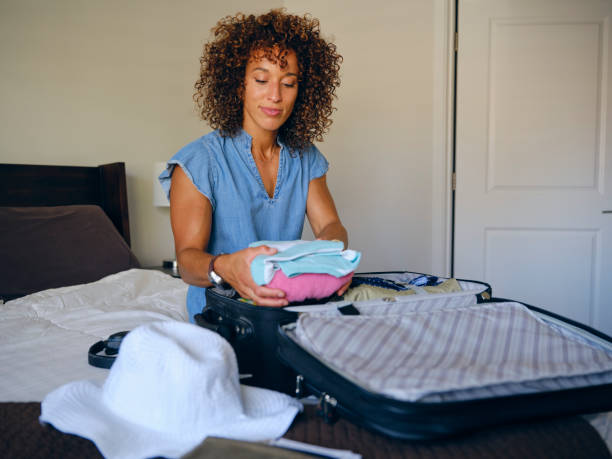 istock Woman Packing a Suitcase 1327336688