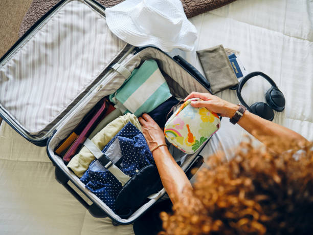 istock Woman Packing a Suitcase 1327336724