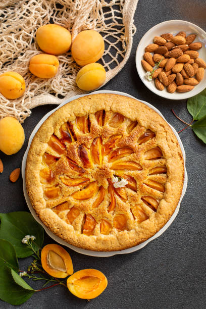 istock Apricot and almonds pie. Homemade. Vertical image, dark background. 1327338671